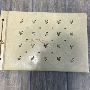 Antique scrapbook. Black paper pages. String tie binding, cream cover.